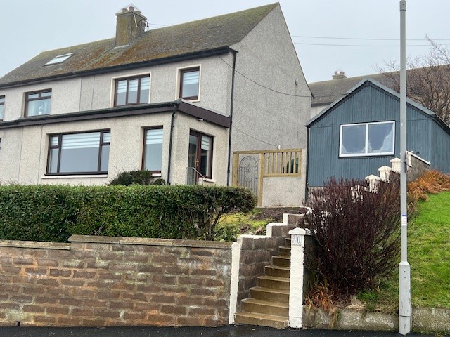 Front exterior of a semi-detached house on Garden Crescent in Gardenstown, overlooking the bay